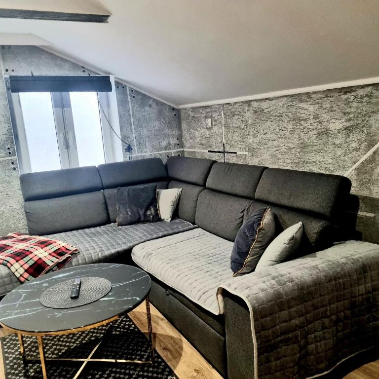 a living room with a couch and a table at Dom Kopernica 5 in Chełm