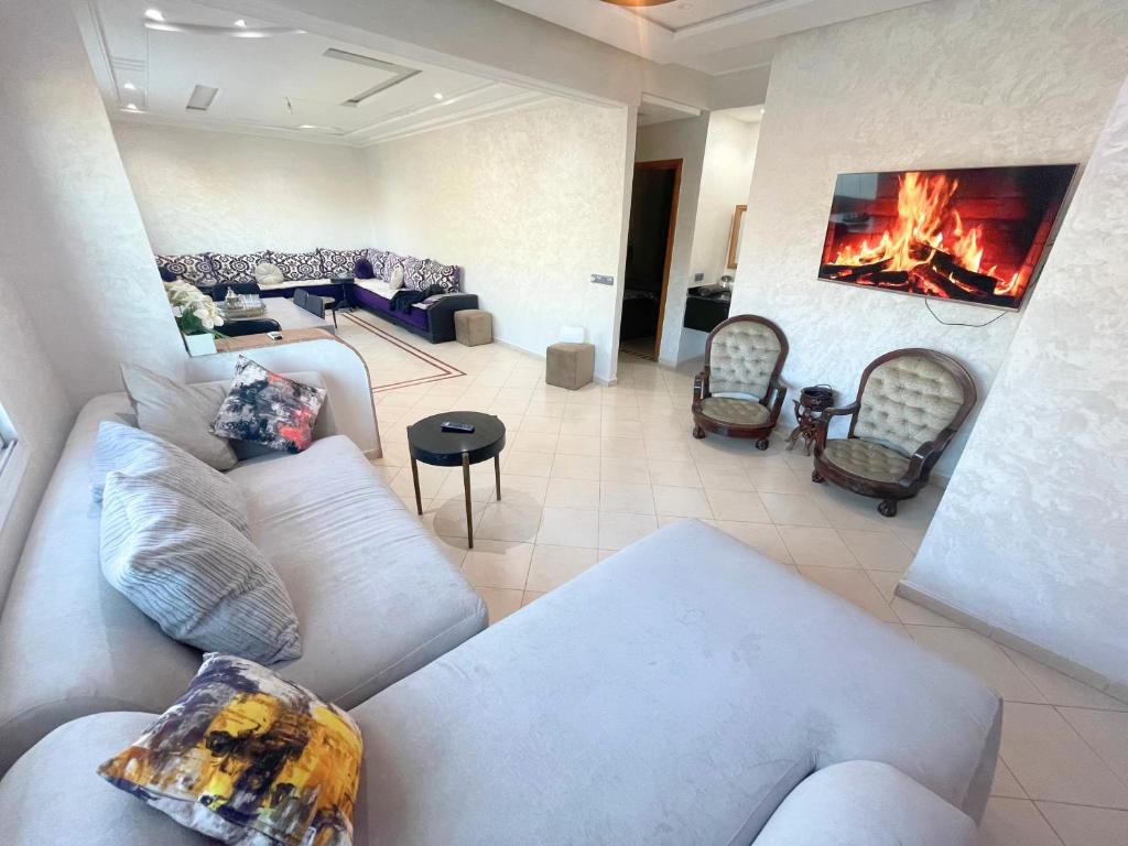 a large living room with couches and a fireplace at 2 BR apartment - City Center Residency - Panoramic City Views - 3 Min Train Access by ZenStay in Fès