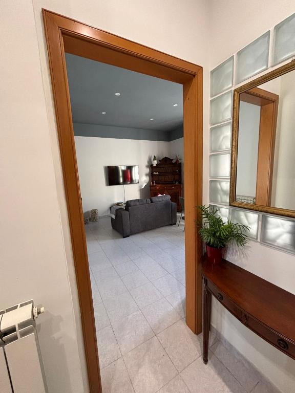 a living room with a mirror and a couch at LillaBloom in Nocera Inferiore