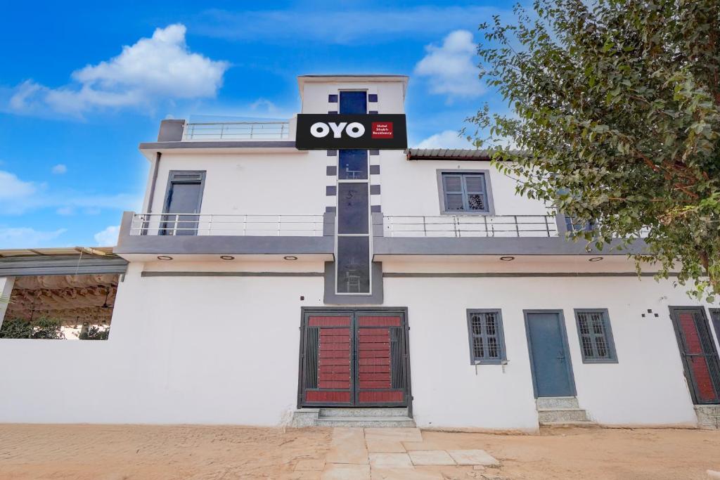 a building with a sign on the front of it at Hotel O Shubh Residency in Bhundsi
