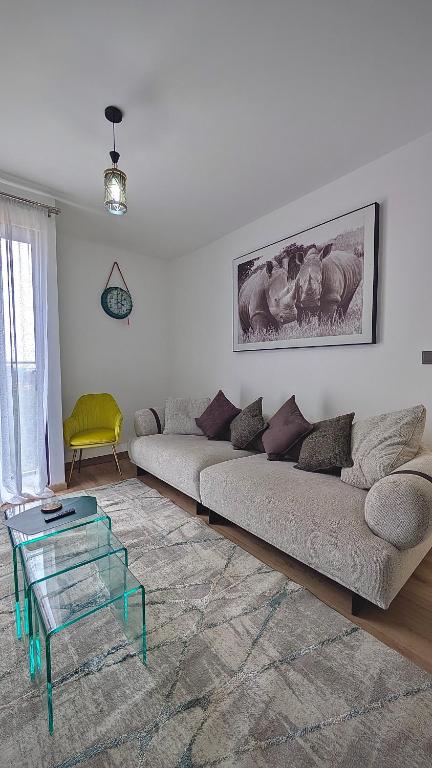 a living room with a couch and a glass table at Mimi homes in Tatu City