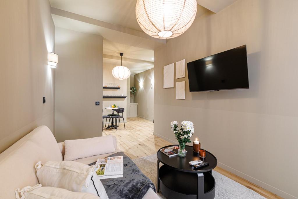a living room with a couch and a tv on a wall at Wonderful Stay close to Garibaldi - Aircon in Nice