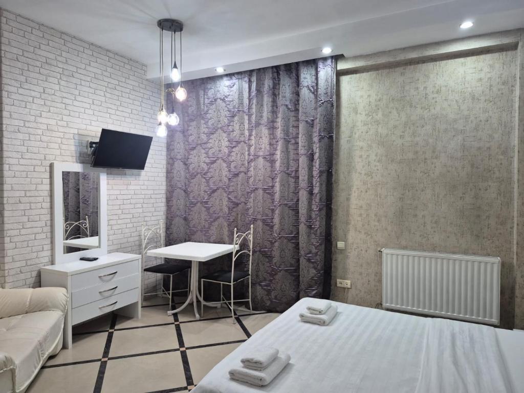 Ένα ή περισσότερα κρεβάτια σε δωμάτιο στο GX Hotel