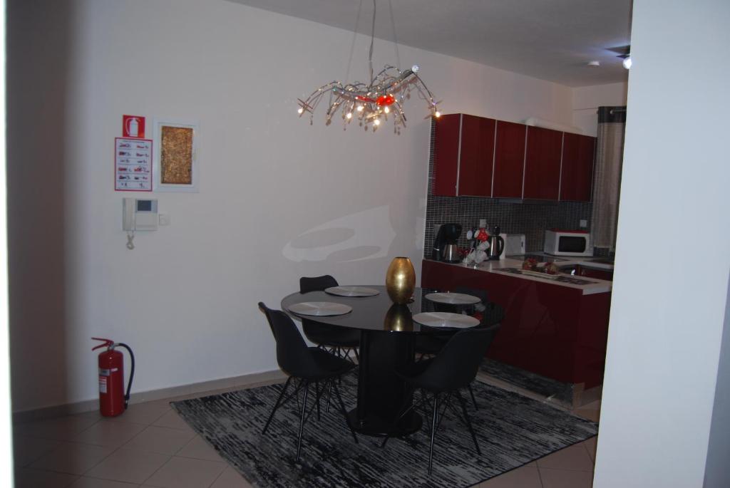 a dining room with a table and chairs in a kitchen at sofi in Komotini