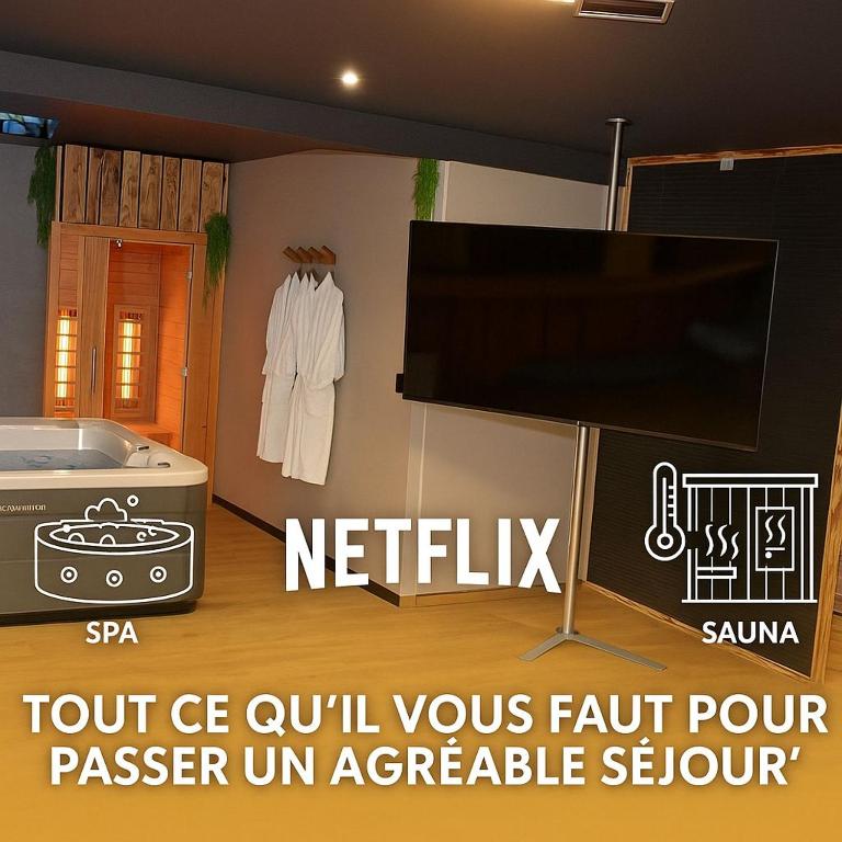 a room with a tv and a bath tub at La Parenthèse SPA in Arc