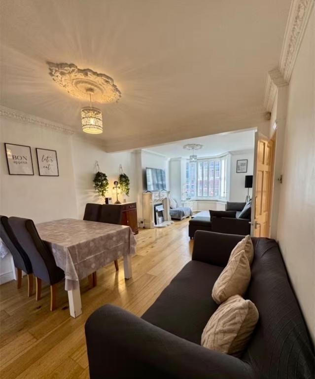 a living room with a couch and a table at Three Bees in Hythe