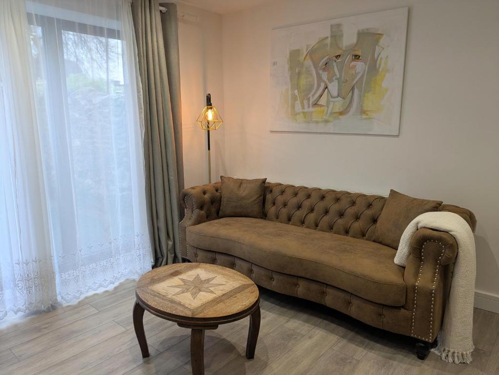 a living room with a couch and a table at 2 bedroom house with yard in Cardiff