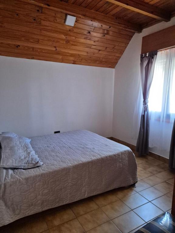 a bedroom with a large bed and a window at La Casa De Yayo in San Luis