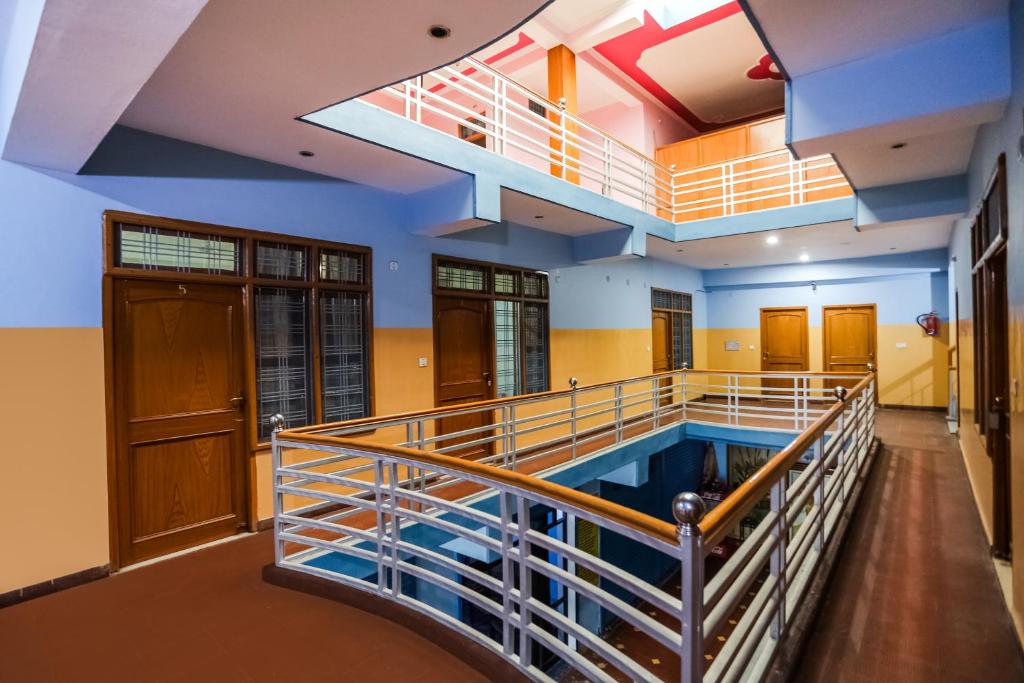 a large room with a swimming pool in a building at SPOT ON Kailash Hotel in Chūharpur