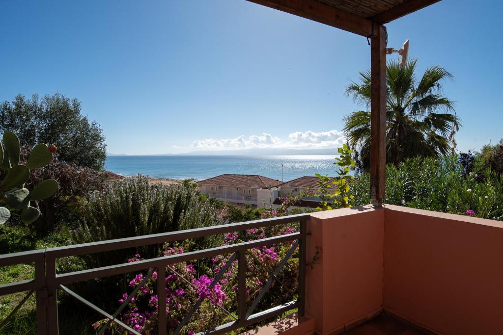 a view of the ocean from the balcony of a house at Mounda Beach Retreat in Skala