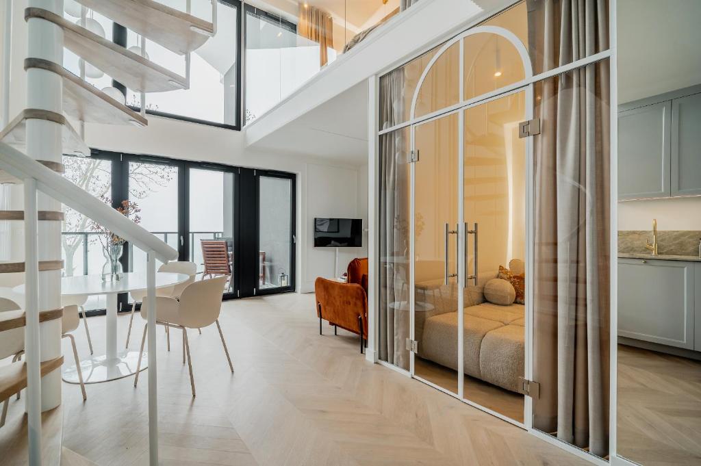 a bedroom with a bed and a living room at Zegrze Lake Apartament przy Narwi LEKKO z sauną in Zegrze