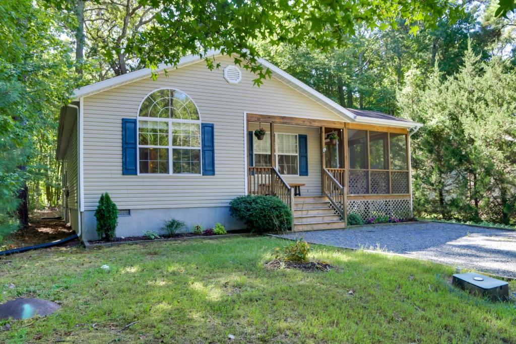 a small white house with a porch at Quiet Ocean Pines Retreat Dogs Welcome! in Ocean Pines
