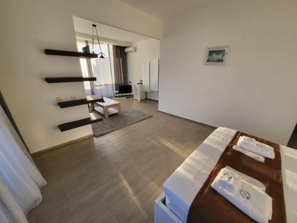 a room with a staircase and a living room at Hotel SABA in K'obulet'i