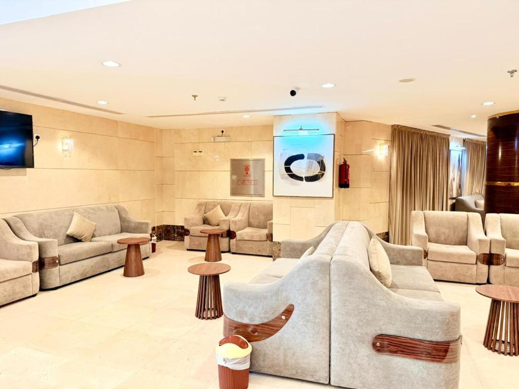 a large living room with couches and tables at Mizab Hotel From Nebras Alhuda in An Naqāʼ