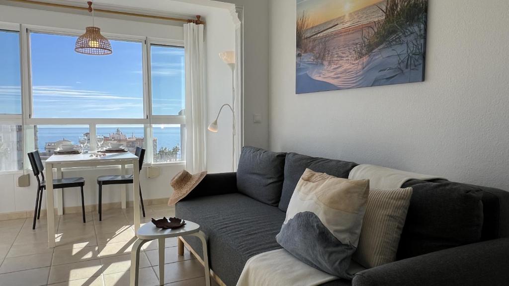 a living room with a couch and a table at Carabela-C704 in Torrox Costa