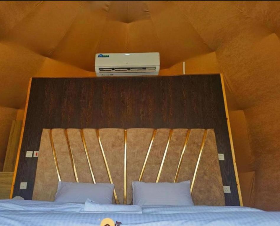 a bed with a box on top of it at Wadi Rum Bubbles Wissam camp in Wadi Rum