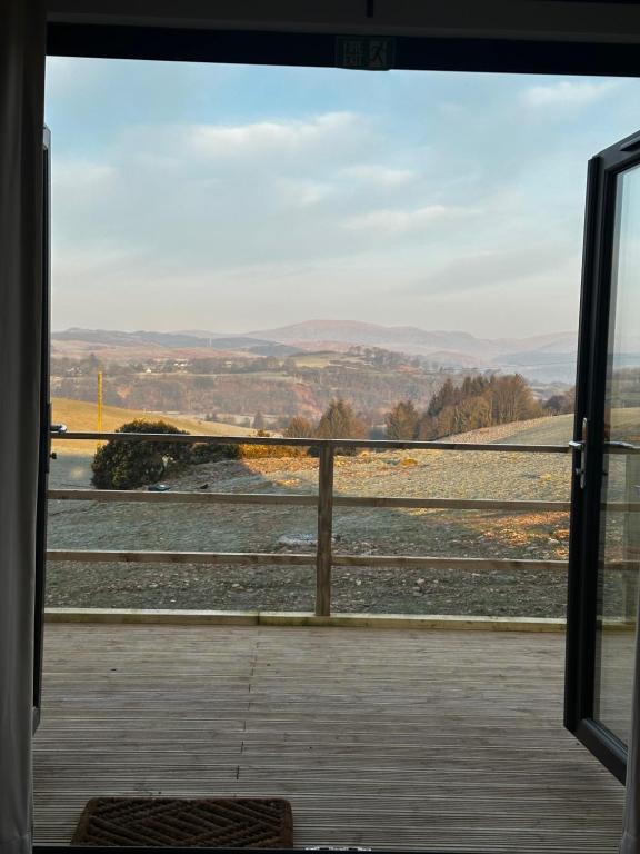 a view from a window of a train yard at The Byre, Summerhill Farm Stays in Balmaclellan