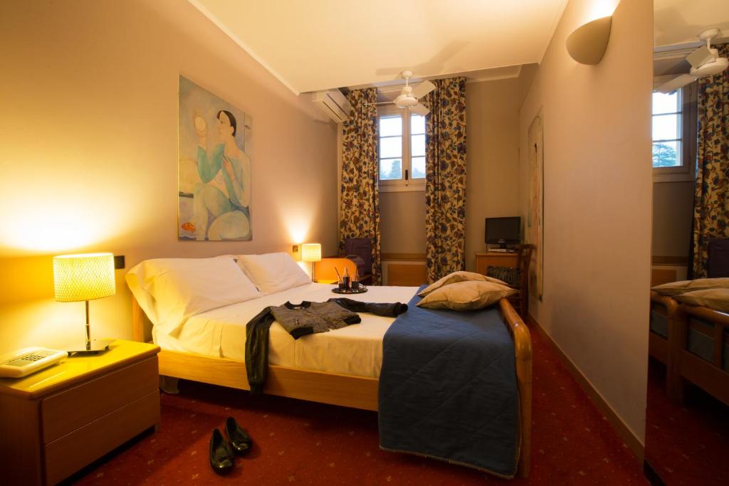 Postel nebo postele na pokoji v ubytování Albergo Giardino