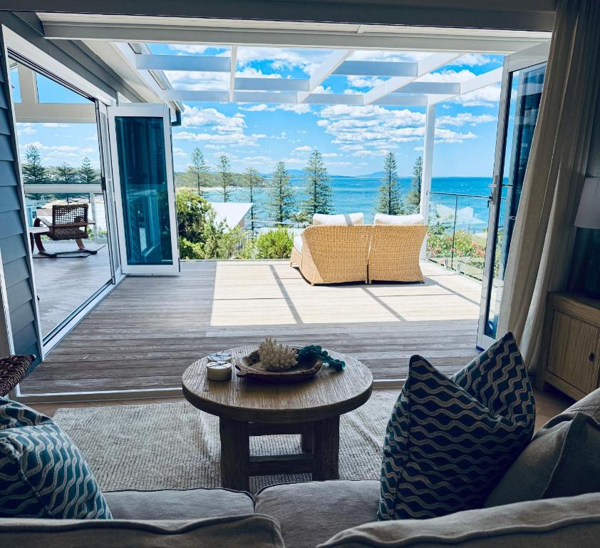 a living room with a view of the ocean at Barbara's Beach House in Hallidays Point