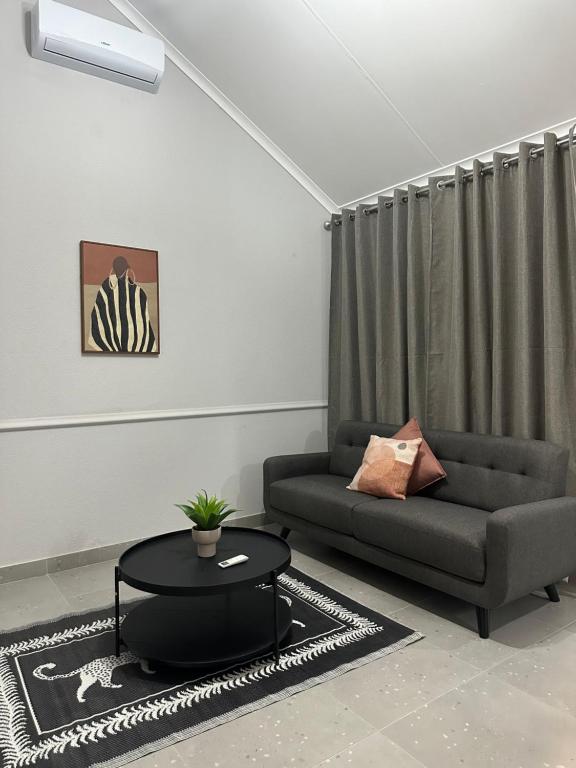 a living room with a couch and a table at Pendleberry Grove 90 in Bela-Bela