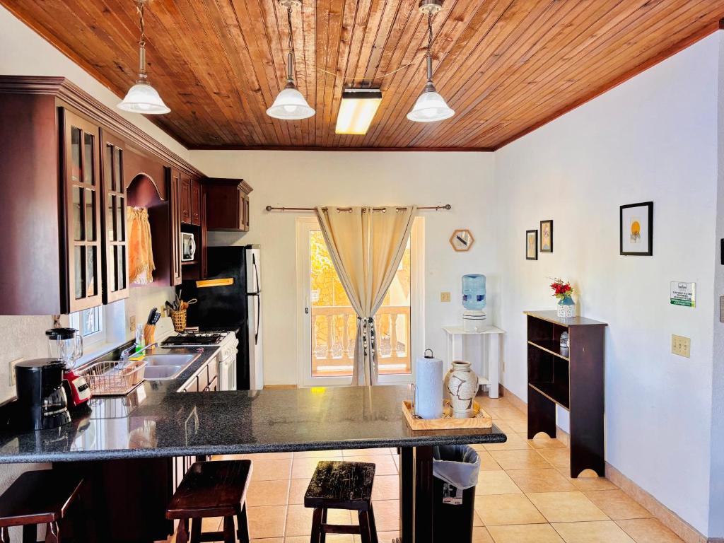 a kitchen with a large island in a room at Sunset Views Apartment, West End in West End