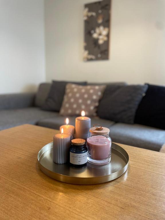 a tray with candles on top of a table at Brusta Stugor in Ödkarby