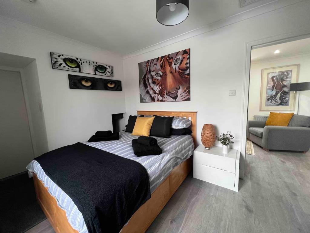 a bedroom with a large bed and a couch at Stylish One Bed Apartment in Edinburgh
