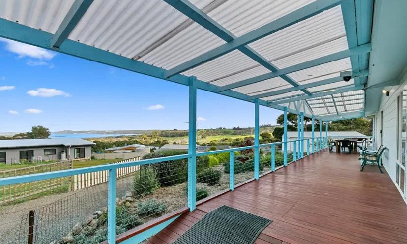 a deck with a view of the ocean from a house at Blue Lagoon in American River