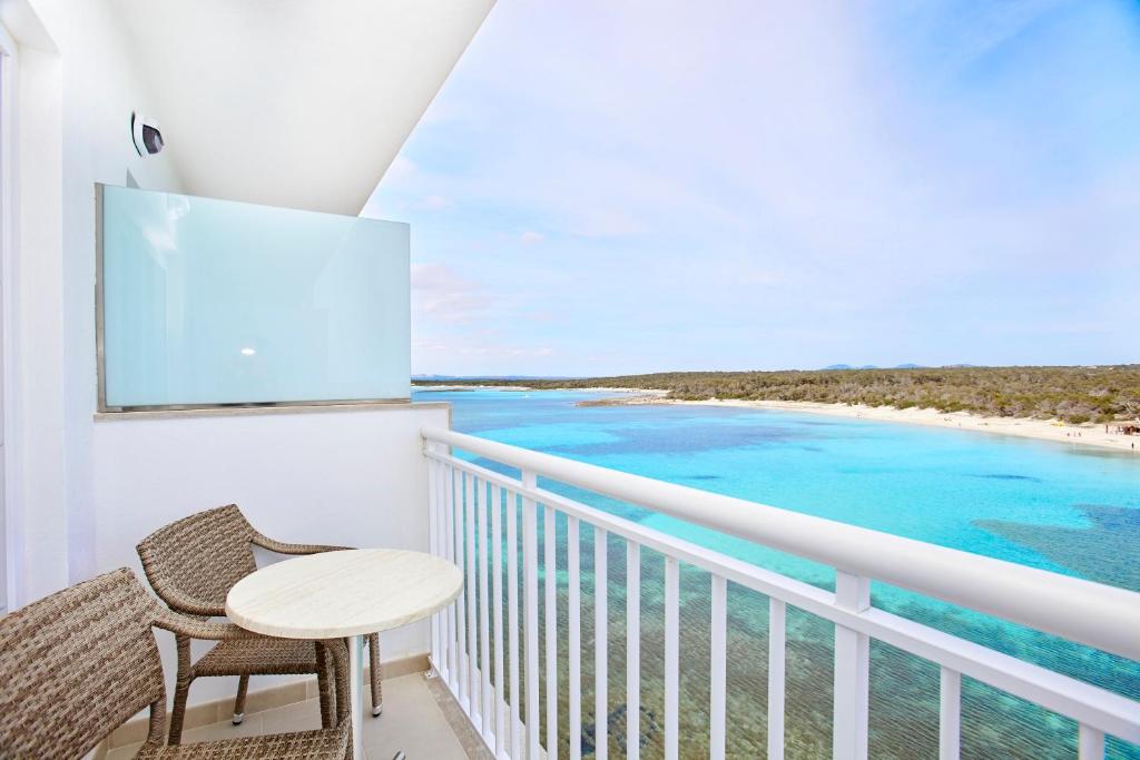 a balcony with a table and chairs and the ocean at Universal Hotel Marqués in Colònia de Sant Jordi