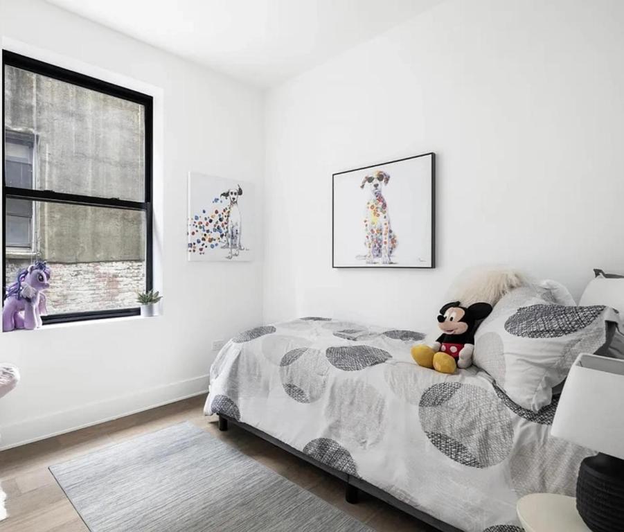 a bedroom with a bed with a stuffed animal on it at Modern Upper West Side Private Room by Central Park in New York