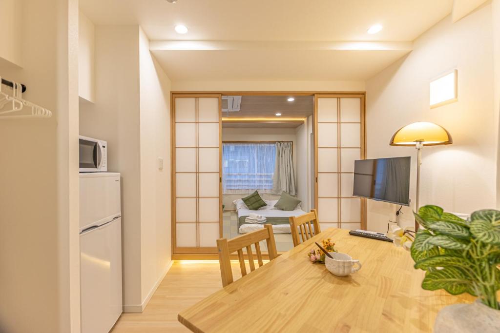 a kitchen and living room with a table and a television at New mansion 7 mins from Yoyogi stations in Tokyo