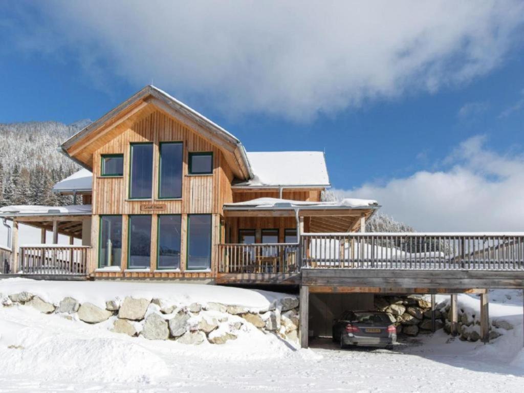 una casa de madera con terraza en la nieve en The Laerch, en Hohentauern