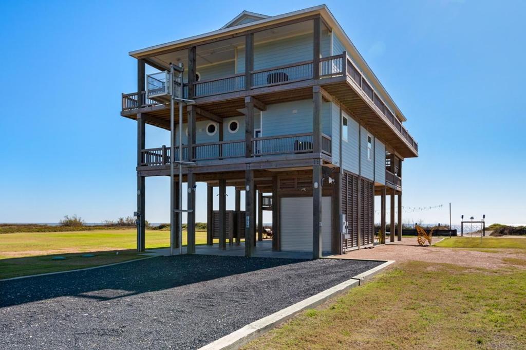 a house with a balcony on the side of it at Deja Blue home in Caplen