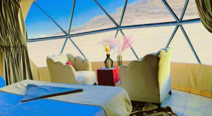 a bedroom with a view of the ocean from a window at Wadirum Leen camp in Wadi Rum
