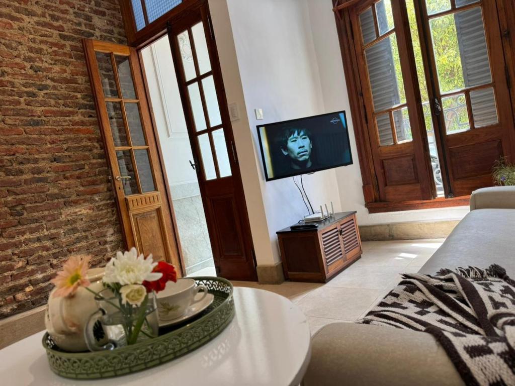 a living room with a couch and a tv at Casa37 in Buenos Aires