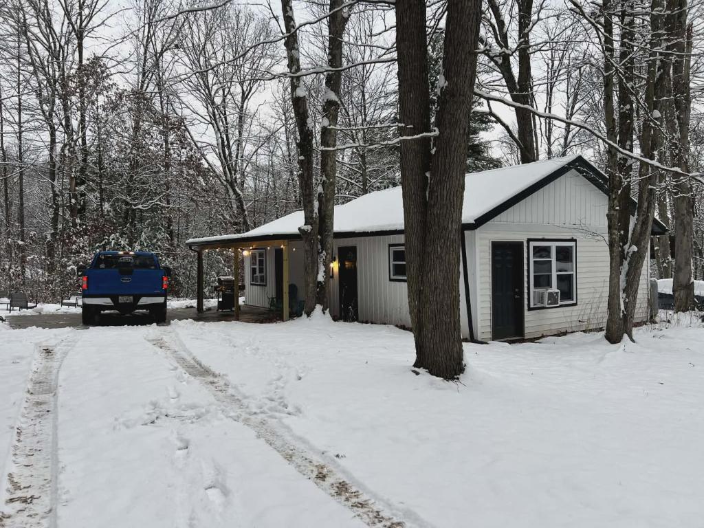 a house in the snow with a truck parked next to it at The Reel Freedom Cottage at Leesville Lake in Carrollton