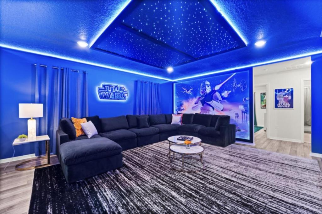 a living room with blue walls and a blue ceiling at New Orlando Pool Vacation Home Near Disney in Clermont