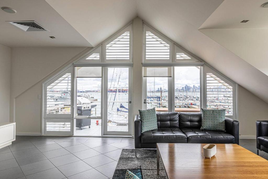 a living room with a couch and a large window at MainStay Suites Williamstown in Williamstown