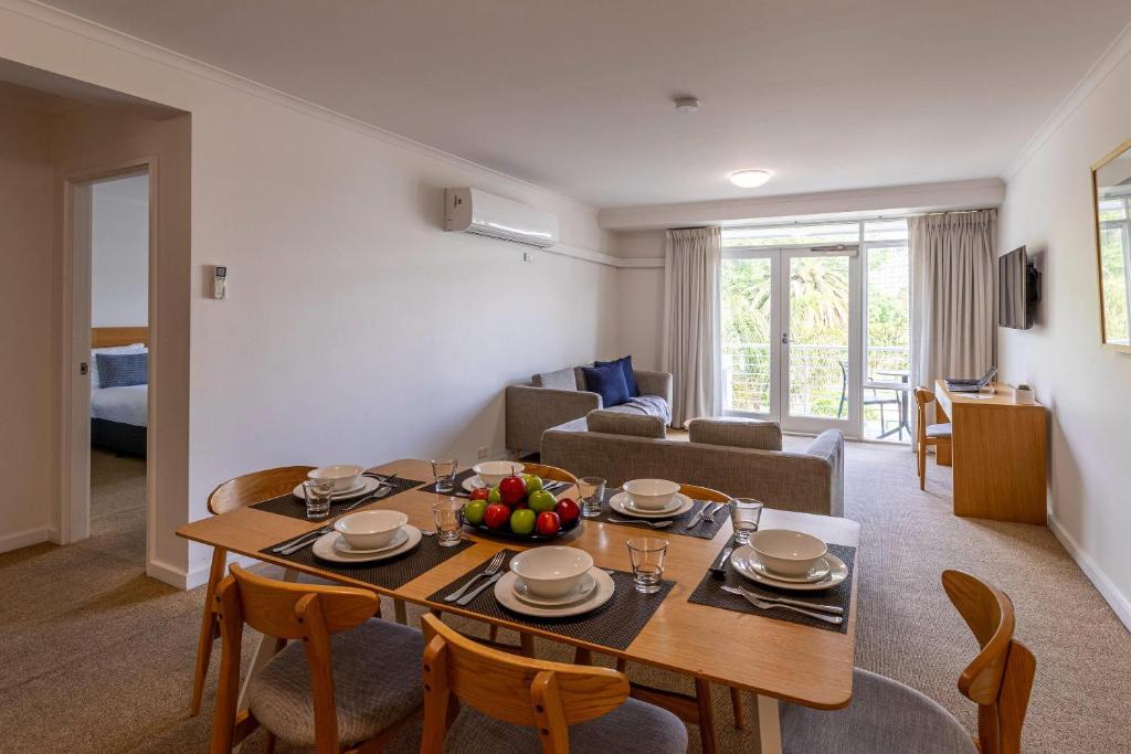a living room with a table and chairs and a couch at MainStay Suites Williamstown in Williamstown