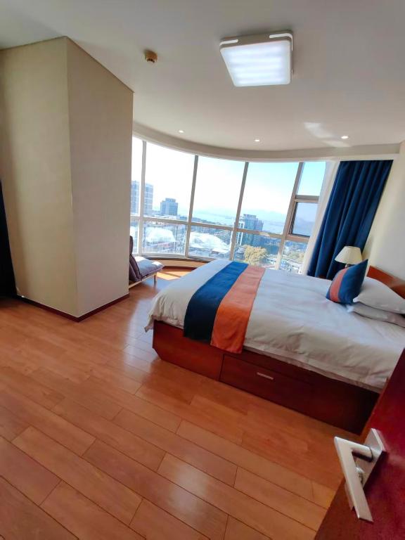 a large bedroom with a bed and a large window at East King Business Hotel (West Lake store, Hangzhou) in Hangzhou