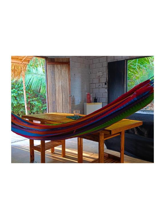 a hammock on a table in a room at Casa Segredo da Mata in Alter do Chao
