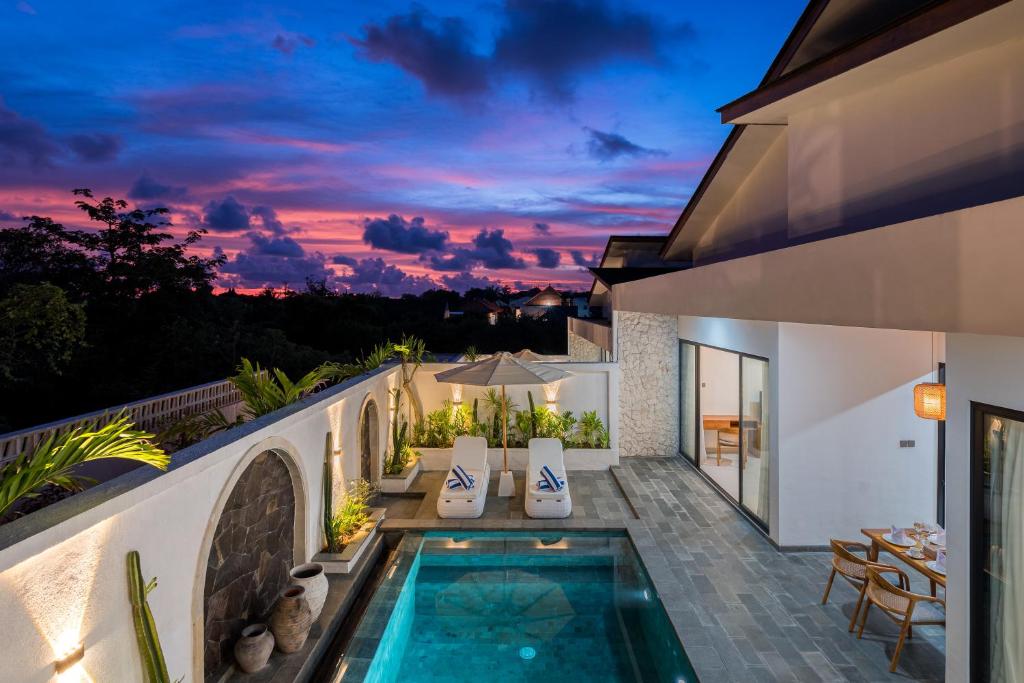 a house with a swimming pool and a patio at Diwangkara Villa Pandawa in Ungasan