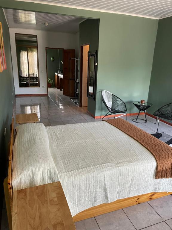 a bedroom with a large bed in a room at Big Sloth Apartment in Fortuna