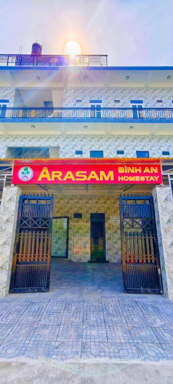 a building with a red sign on top of it at Arasam Homestay Bình An in Ấp Thanh Sơn (1)