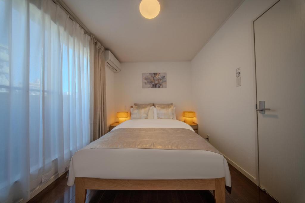 En eller flere senge i et værelse på Seiha 中川西