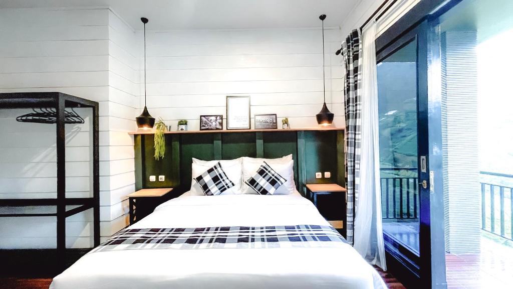 Ένα ή περισσότερα κρεβάτια σε δωμάτιο στο The Noman Tawangmangu by Suasana Villa