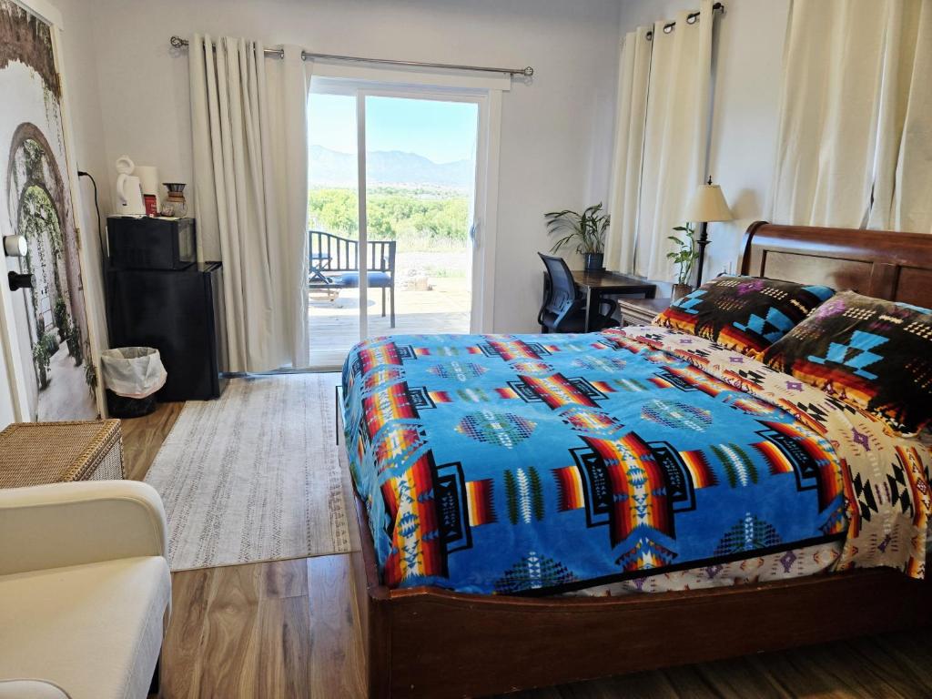 a bedroom with a bed with a blue comforter at Stargazing Retreats Homestay in Camp Verde