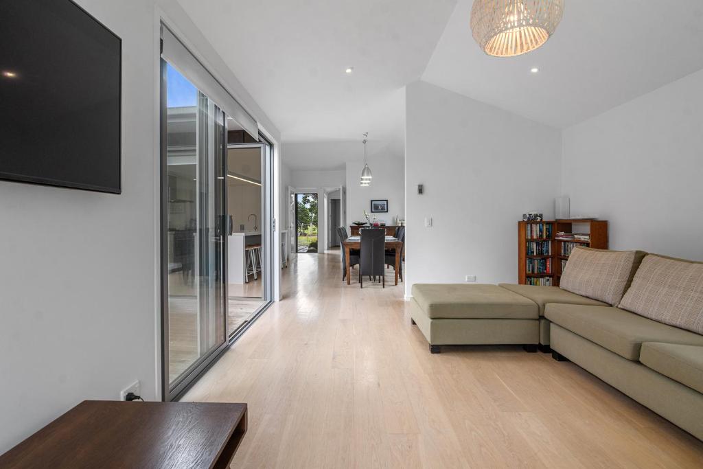 a living room with a couch and a tv in it at White Sands Haven - Omaha Family Escape in Omaha