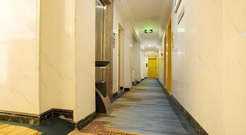 an empty hallway of an office building with a long corridor at JTOUR Inn Zhanjiang Poly Yuandian Plaza in Zhanjiang