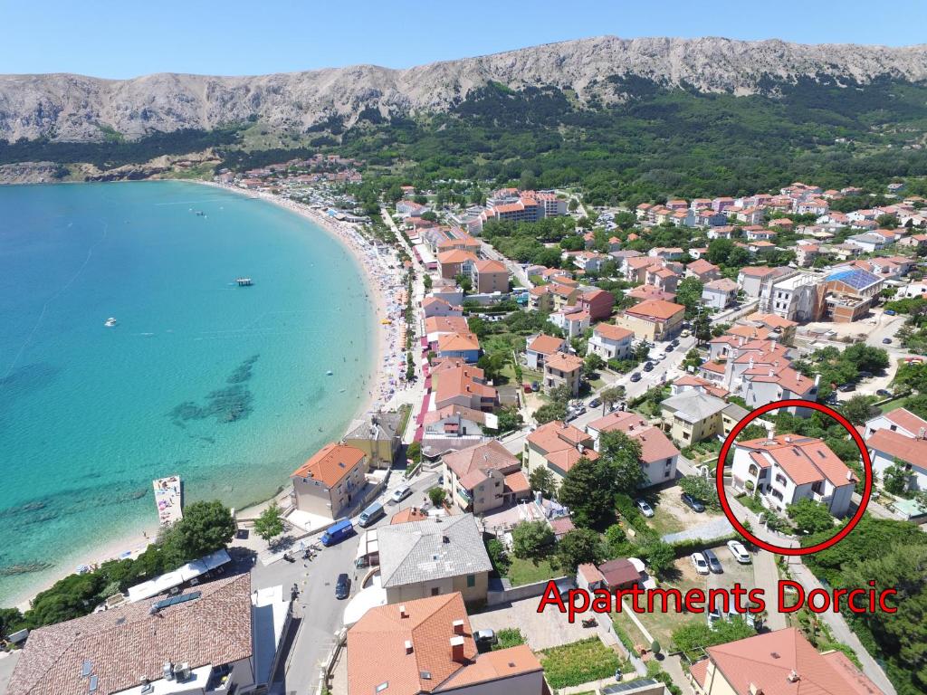 a view of a town with a sign that reads apartments depot at Apartments Zlatko and Mira Dorcic in Baška